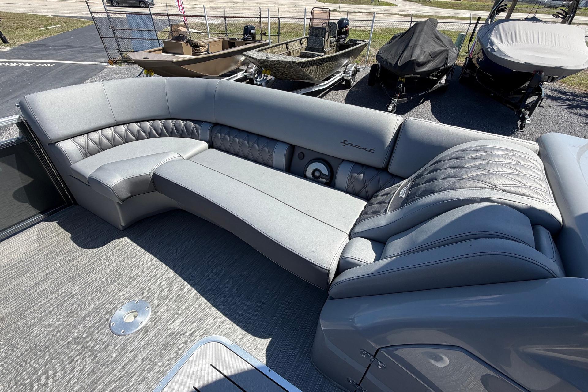 2022 Bennington 25 QX boat interior with luxurious gray seating and quilted design.