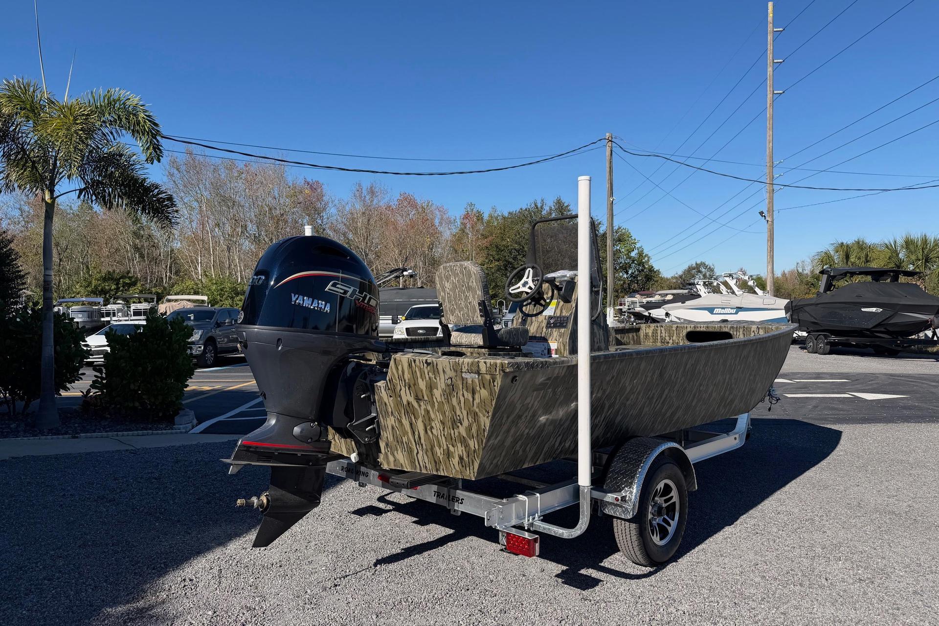 2026 Smoker Craft Sportsman 1866 boat with Yamaha engine on trailer, parked outdoors.